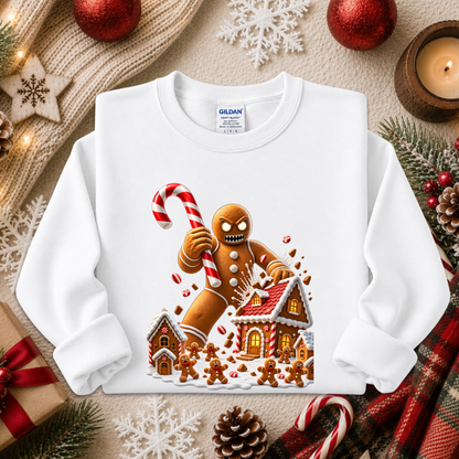 a white sweatshirt with a graphic design of an evil gingerbread man that is attacking a gingerbread town and other gingerbread people are screaming and running away and he's holding a giant candy cane