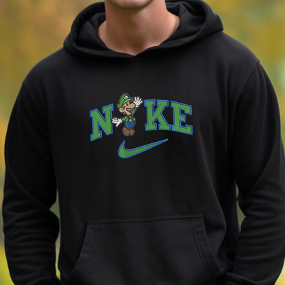 A person wearing a black hoodie with a graphic on the chest that reads 'NIKE' in green and blue, featuring a cartoon character and a green swoosh, against a blurred yellow-green outdoor background.