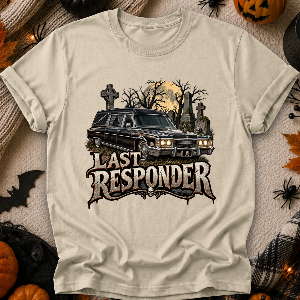 beige tshirt with a graphic design of a cemetery and hearse and it says Last Responder