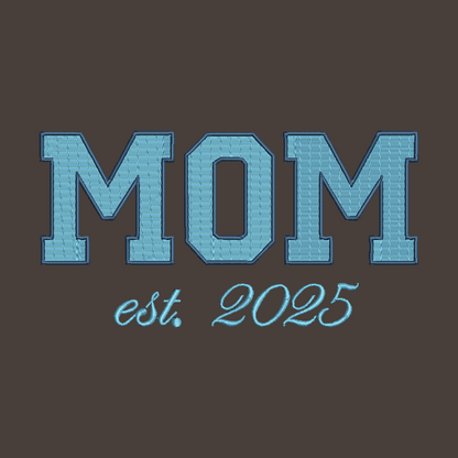A brown square graphic with the word “MOM” in large light blue block letters outlined in darker blue, above the phrase “est. 2025” in a matching light blue script.