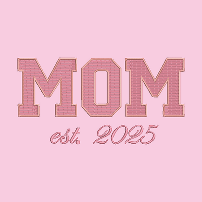 Embroidered-style text reading 'MOM est. 2025' in pink tones on a solid pink background.