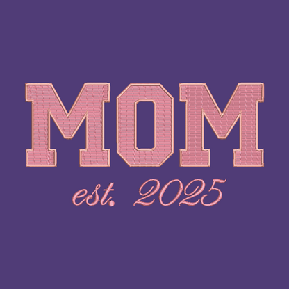 A purple square graphic with the word “MOM” in large pink block letters outlined in a warm gold tone, and “est. 2025” in smaller pink script below.