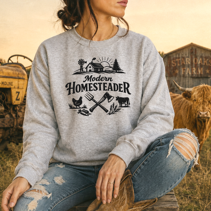 woman wearing a gray sweatshirt with farm graphic that says modern homesteader