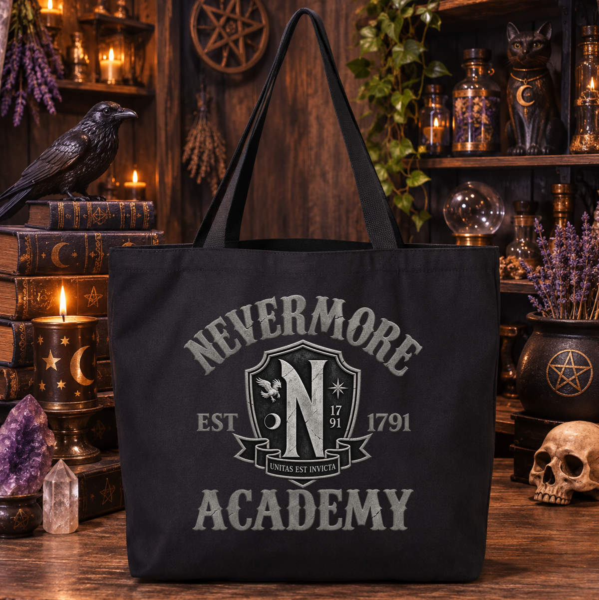 A black tote bag with a distressed gray 'Nevermore Academy' graphic, displayed in a dark, mystical room with candles, books, crystals, and a skull.