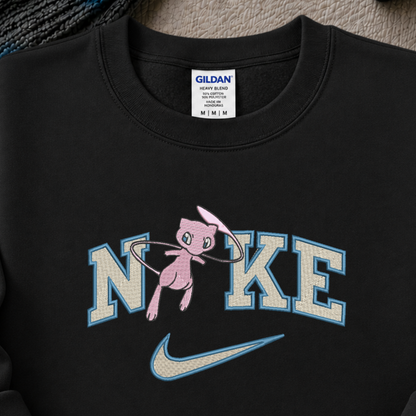 a black sweatshirt with an embroidered design of a pokemon mew character in the NIKE logo with a swoosh