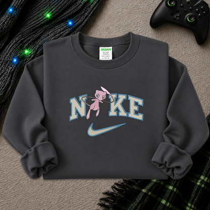 a dark gray sweatshirt with an embroidered design of a pokemon mew character in the NIKE logo with a swoosh