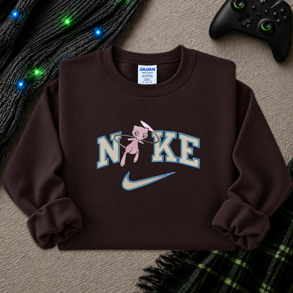 a dark brown sweatshirt with an embroidered design of a pokemon mew character in the NIKE logo with a swoosh
