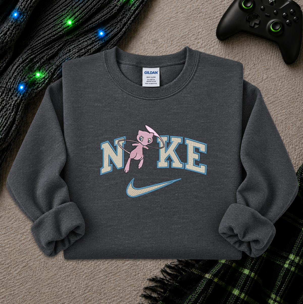 a dark gray sweatshirt with an embroidered design of a pokemon mew character in the NIKE logo with a swoosh