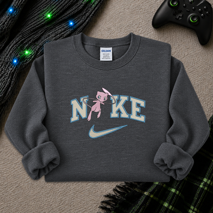 a dark gray sweatshirt with an embroidered design of a pokemon mew character in the NIKE logo with a swoosh