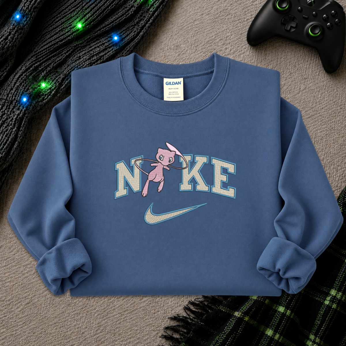 a blue sweatshirt with an embroidered design of a pokemon mew character in the NIKE logo with a swoosh