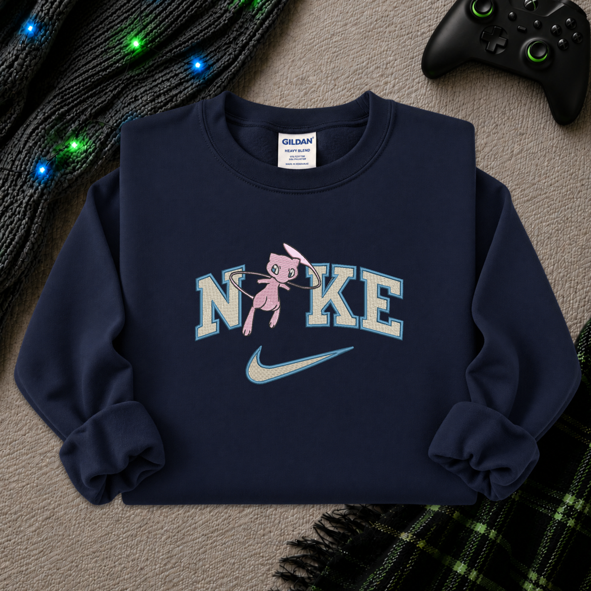 a navy blue sweatshirt with an embroidered design of a pokemon mew character in the NIKE logo with a swoosh