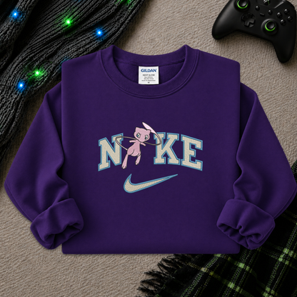 a purple sweatshirt with an embroidered design of a pokemon mew character in the NIKE logo with a swoosh