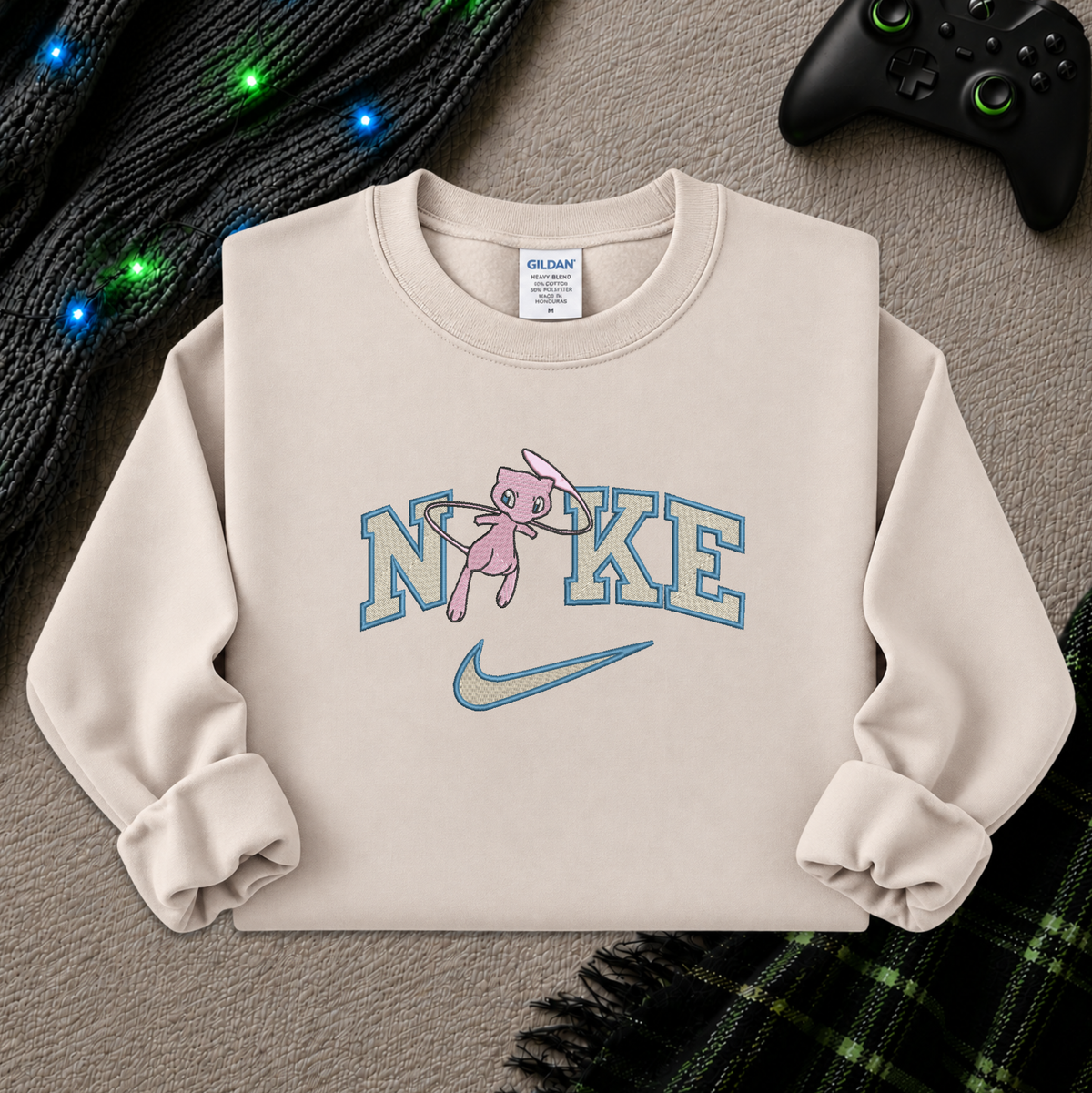 a beige sweatshirt with an embroidered design of a pokemon mew character in the NIKE logo with a swoosh