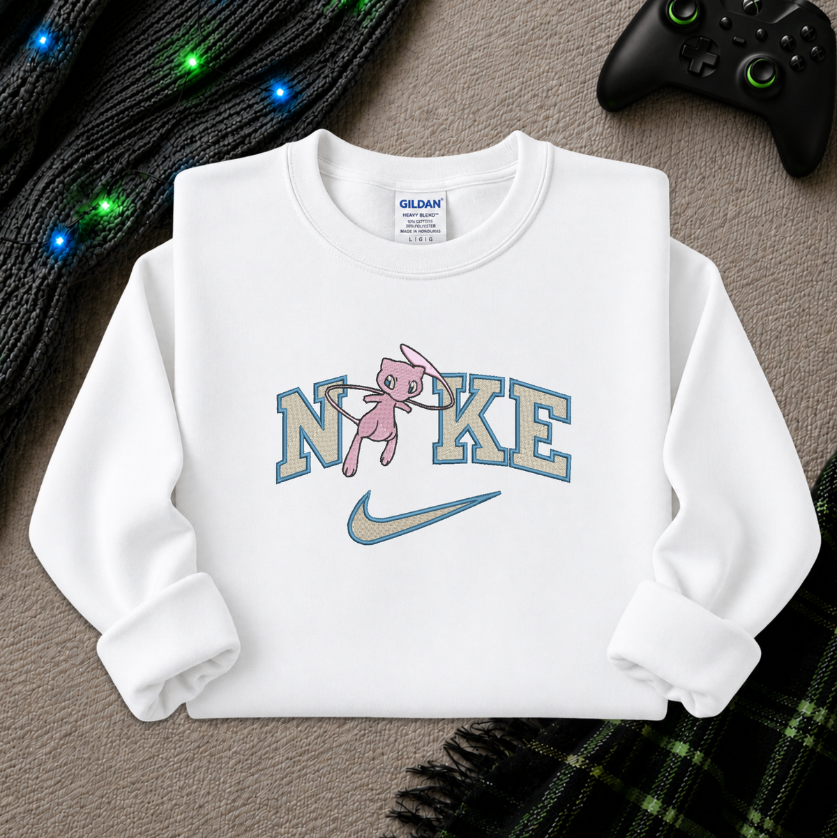 a white sweatshirt with an embroidered design of a pokemon mew character in the NIKE logo with a swoosh