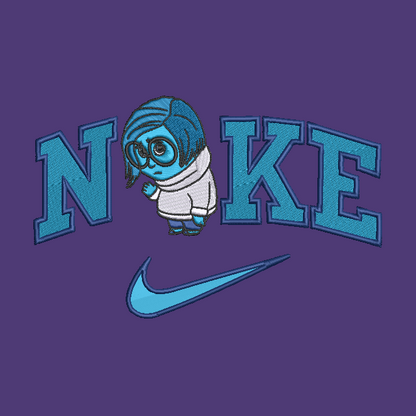 A purple embroidered design featuring the word 'NIKE' in large blue letters with a small cartoon character over the 'I', and a blue Nike swoosh below.