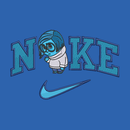 A blue embroidered graphic featuring the word 'NIKE' with a cartoon character forming the letter 'I', and a Nike swoosh below.