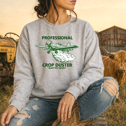 woman wearing a gray sweatshirt with professional crop duster graphic on it