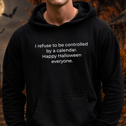 man wearing a black hooded sweatshirt with a text graphic that says I refuse to be controlled by a calendar Happy Halloween everyone