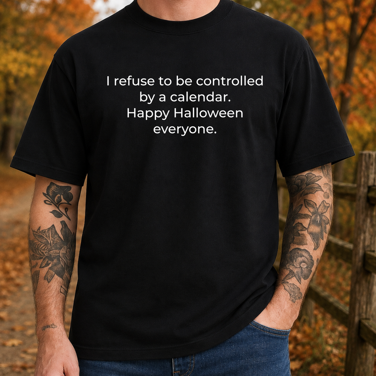 man wearing a black tshirt with a text graphic that says I refuse to be controlled by a calendar Happy Halloween everyone