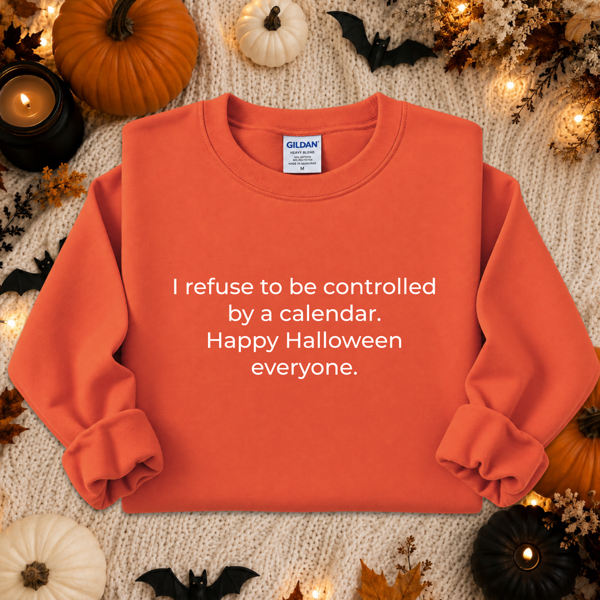 orange sweatshirt with a text graphic that says I refuse to be controlled by a calendar Happy Halloween everyone