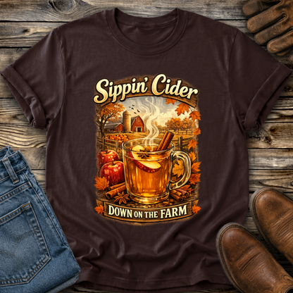 brown tshirt with fall autumn farm scene with a glass of apple cider graphic that says sippin cider down on the farm