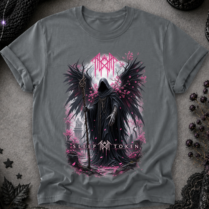 A dark gray graphic t-shirt featuring a gothic illustration of a hooded grim reaper with large black wings, pink flower petals, and a staff, with the text 'SLEEP TOKEN' on a textured gray background.