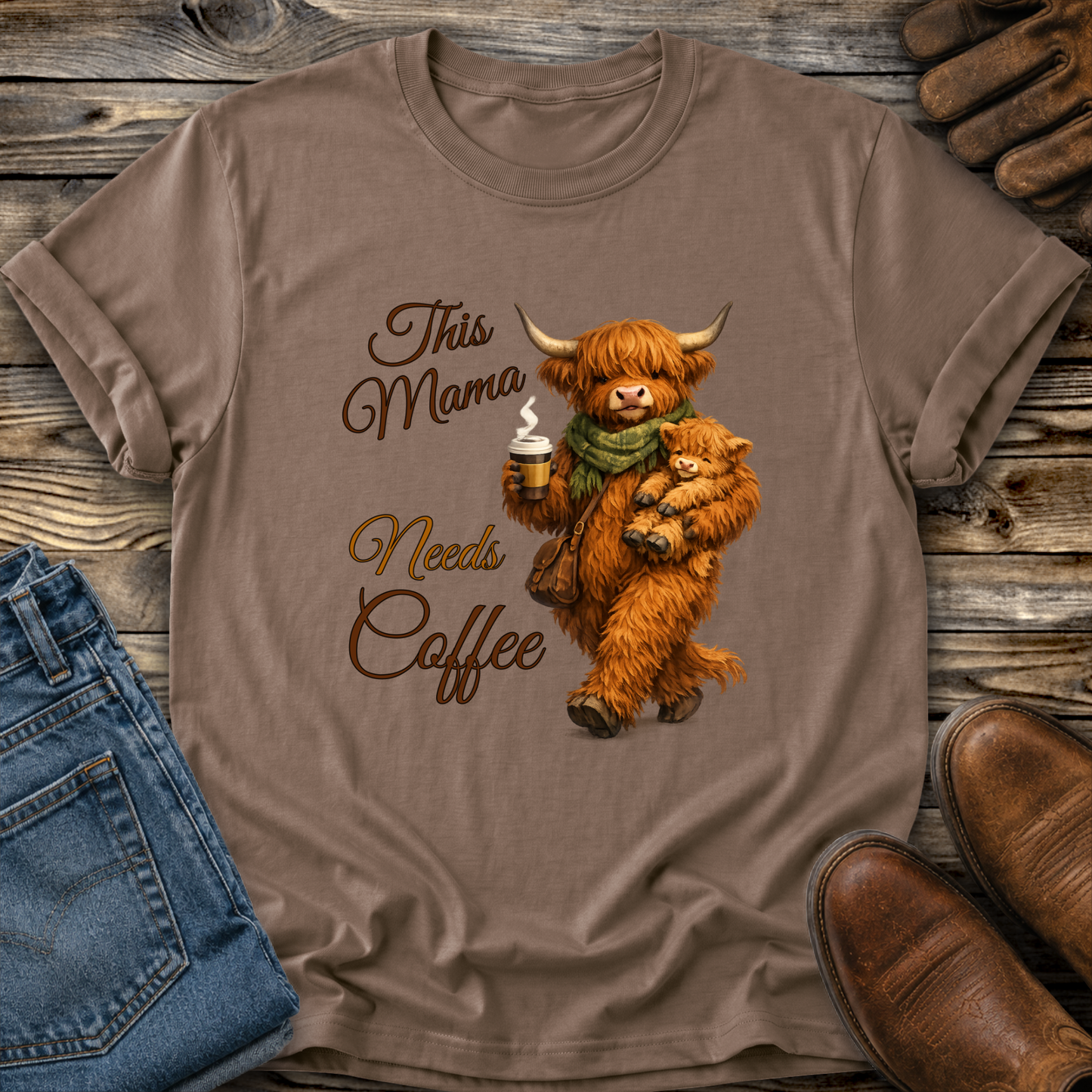 brown tshirt with a highland cow holding her calf and a cup of coffee that says this mama needs coffee