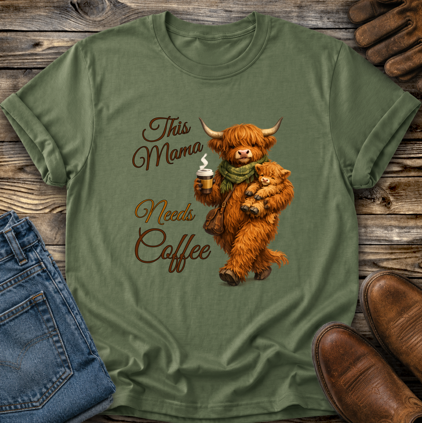 green tshirt with a highland cow holding her calf and a cup of coffee that says this mama needs coffee