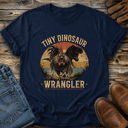 navy tshirt with a distressed graphic of a angry chicken and dinosaur that says tiny dinosaur wrangler