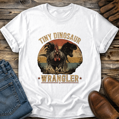 white tshirt with a distressed graphic of a angry chicken and dinosaur that says tiny dinosaur wrangler