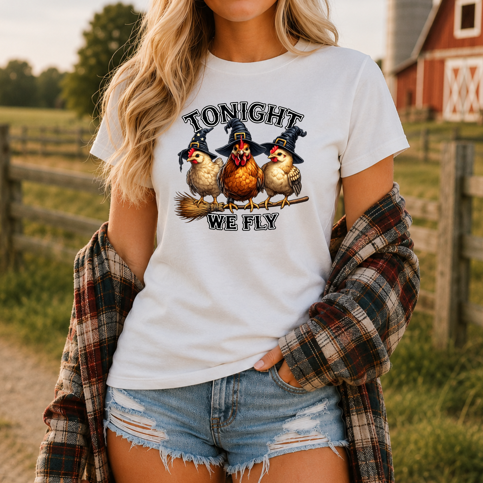 woman wearing a white tshirt with funny chicken witches on a broomstick graphic design that says tonight we fly