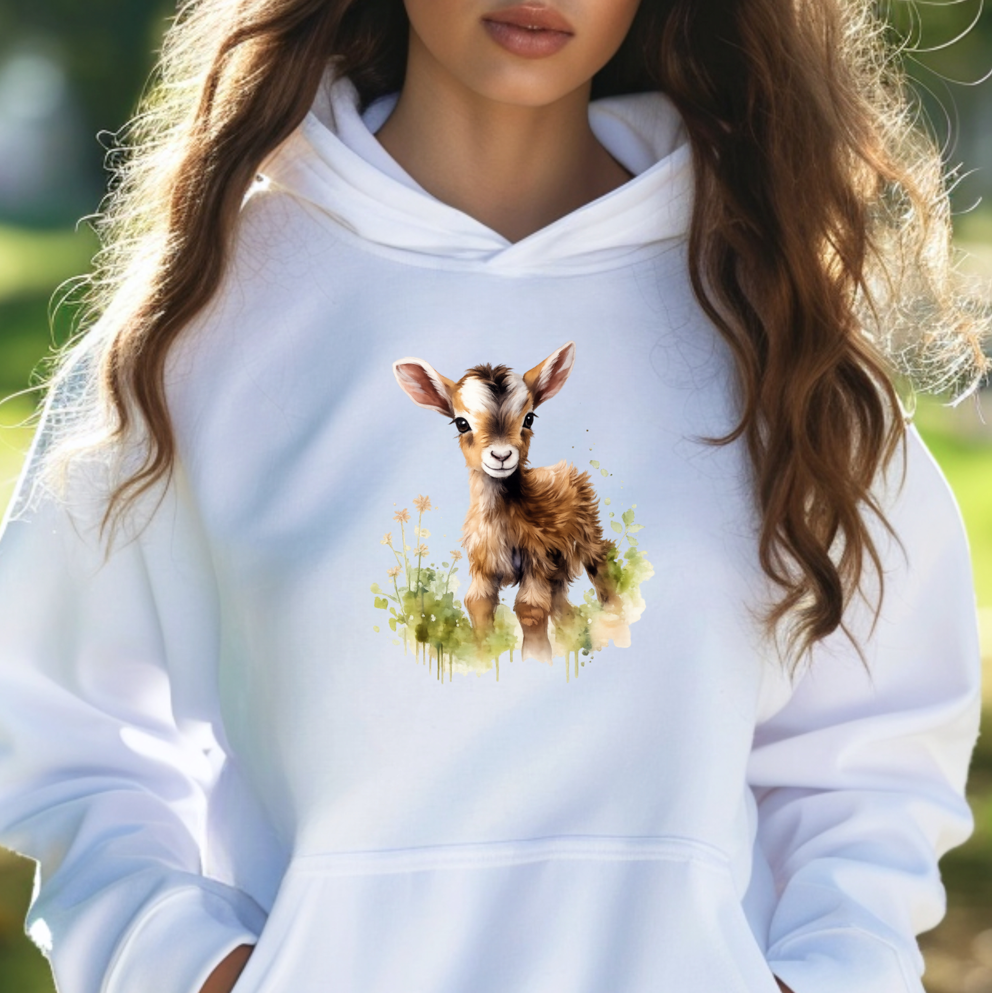 woman wearing a white sweatshirt with a watercolor style baby goat graphic on it