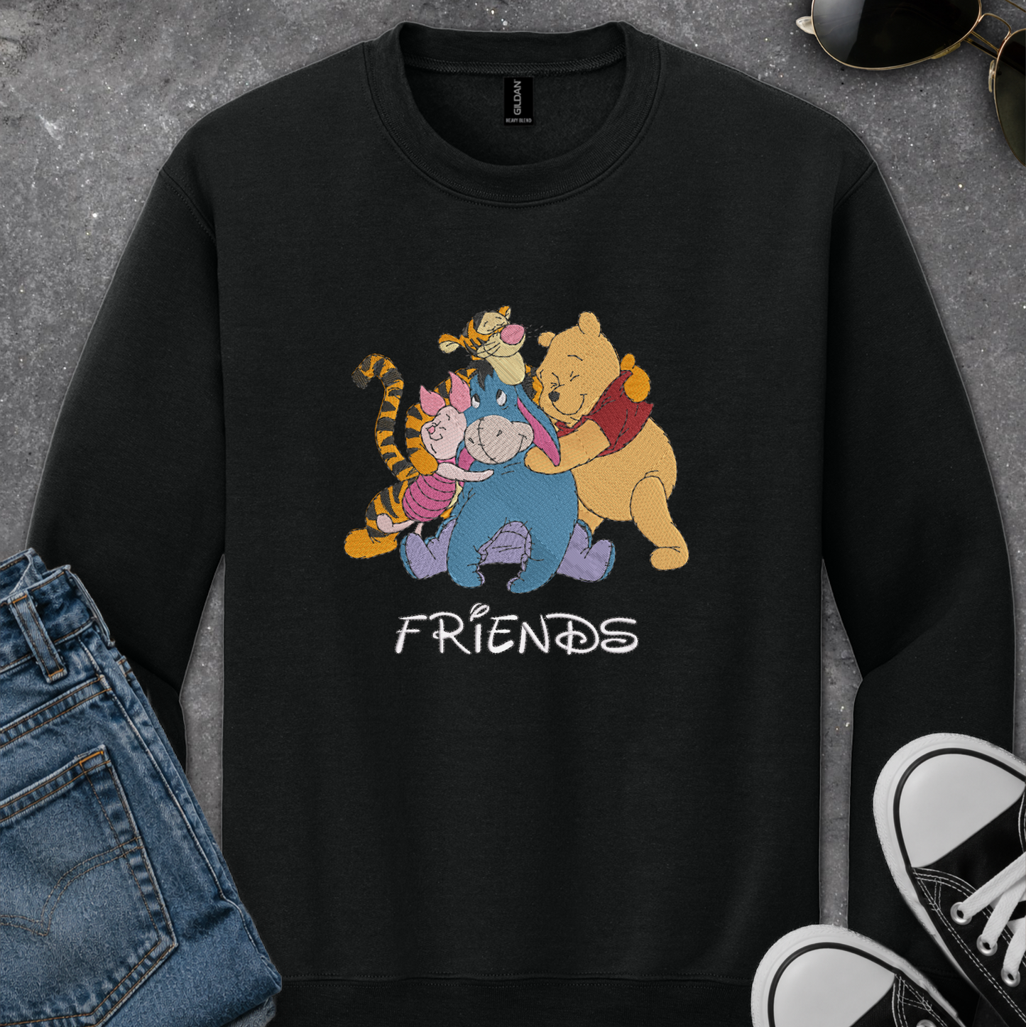 black sweatshirt with an embroidered design of winnie the pooh friends