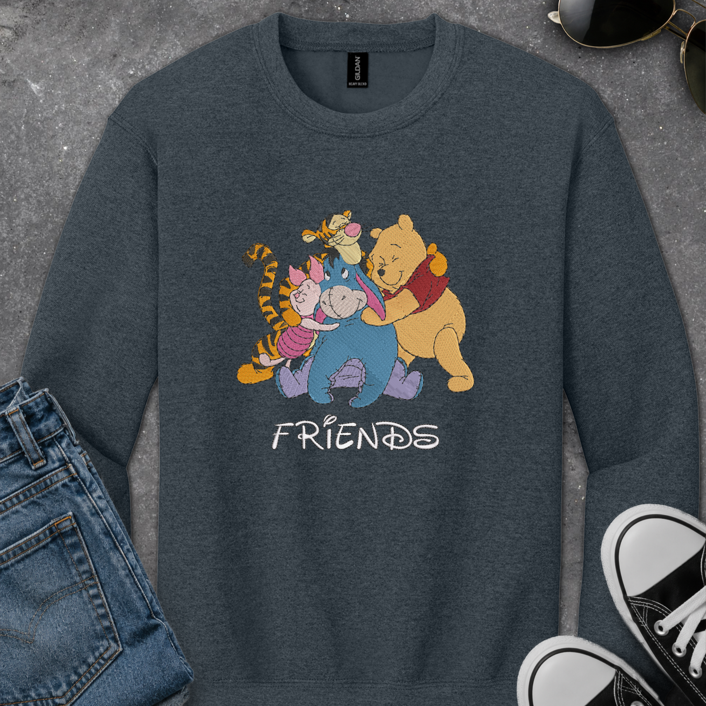 dark gray sweatshirt with an embroidered design of winnie the pooh friends
