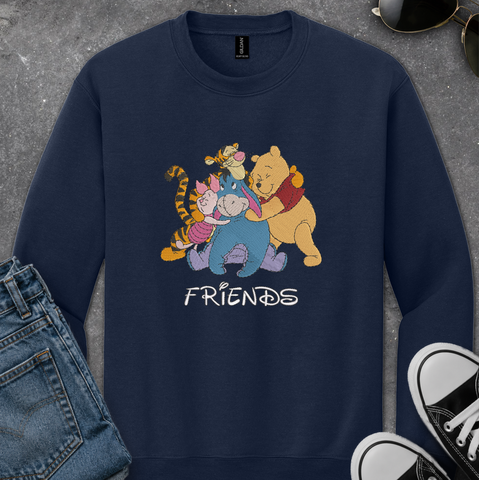 navy blue sweatshirt with an embroidered design of winnie the pooh friends