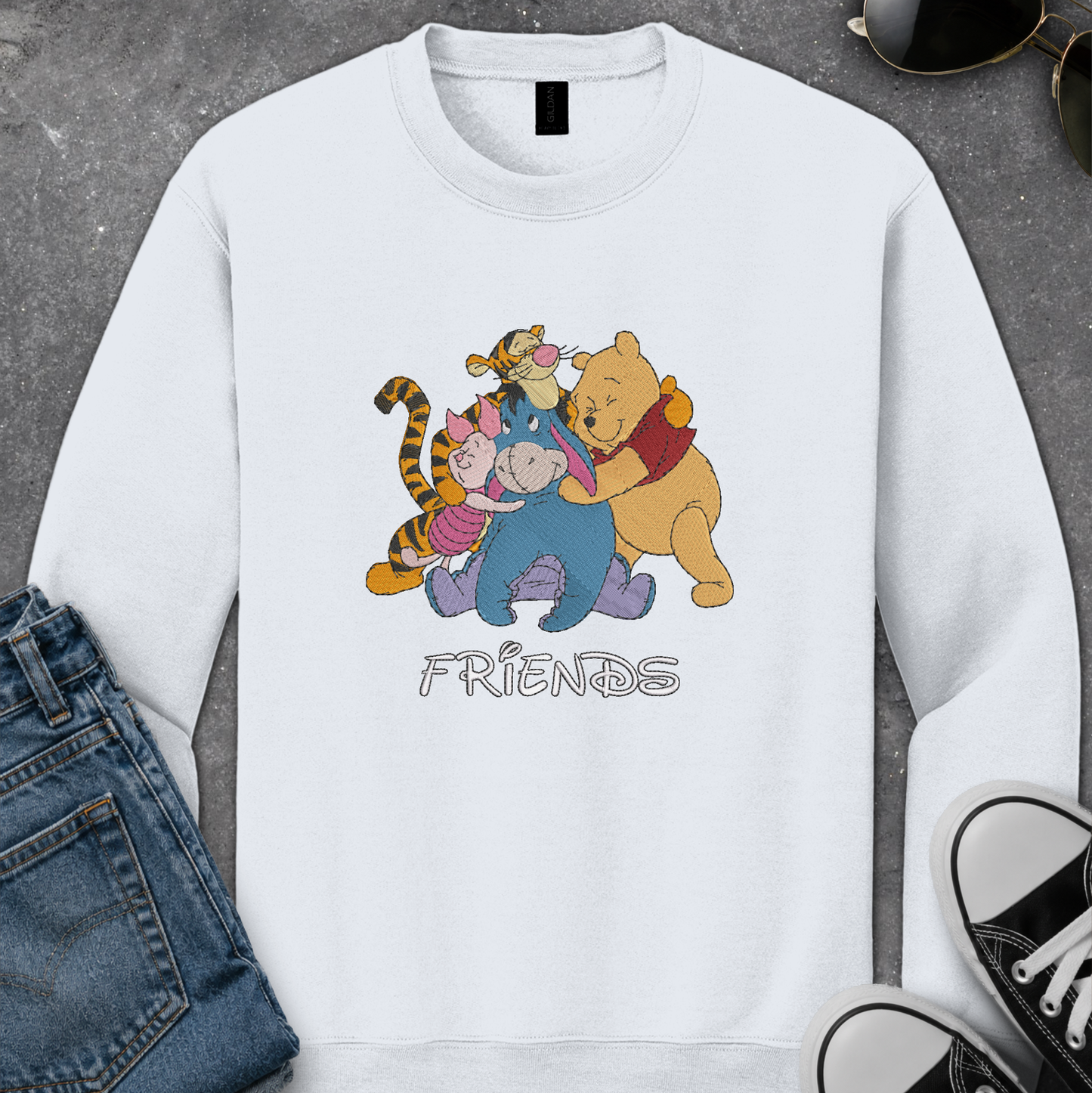 white sweatshirt with an embroidered design of winnie the pooh friends