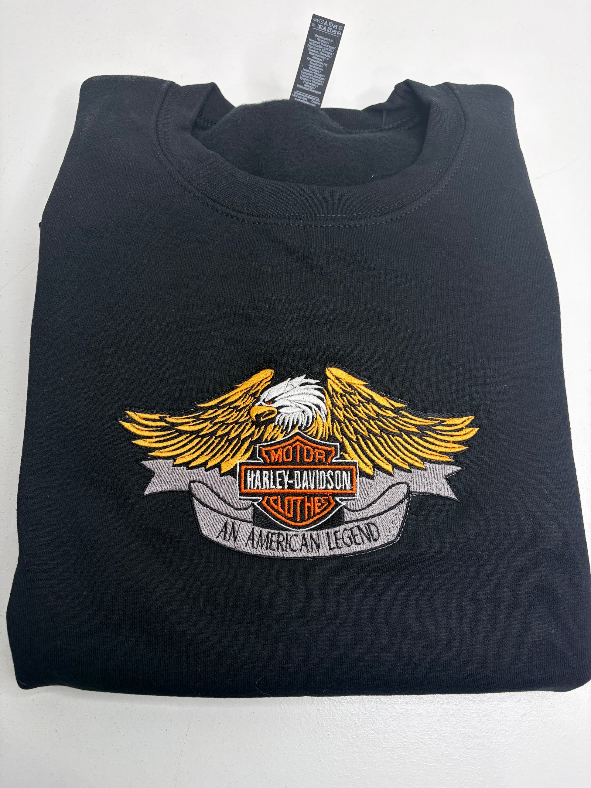 Black sweatshirt with Harley-Davidson logo on a white background