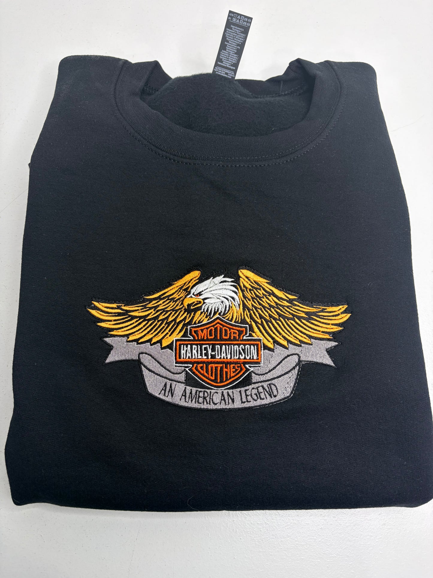 Black sweatshirt with Harley-Davidson logo on a white background