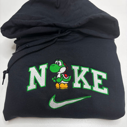 black hooded sweatshirt with an embroidered yoshi and the word nike with a swoosh