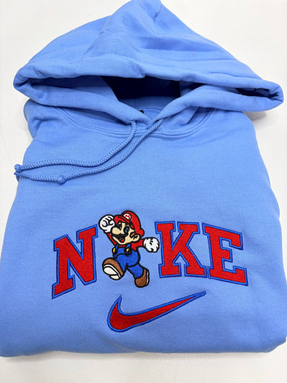 Blue hoodie with mario bros character design and 'NKE' text on a white background