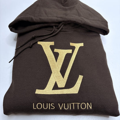 dark brown sweatshirt with a gold embroidered louis vuitton logo