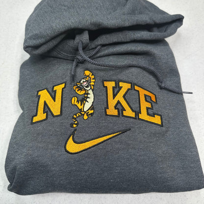 gray sweatshirt with embroidered tigger in the middle of the nike logo