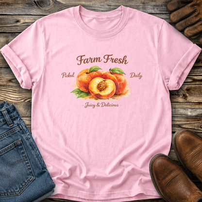 pink tshirt with peaches graphic that says farm fresh picked daily