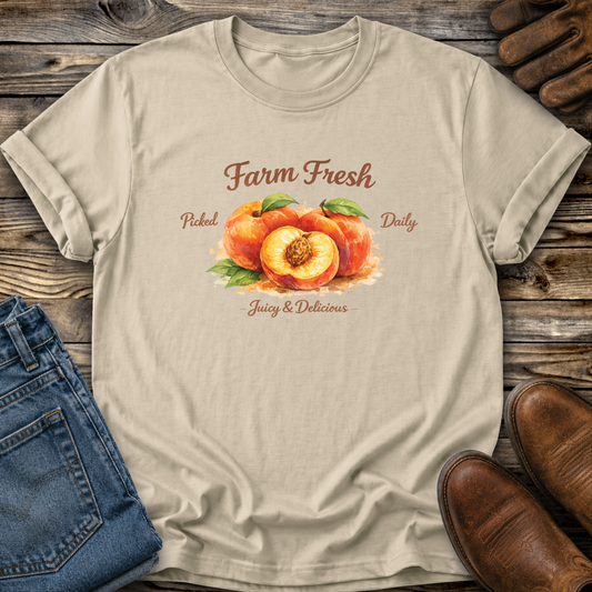 beige tshirt with peaches graphic that says farm fresh picked daily