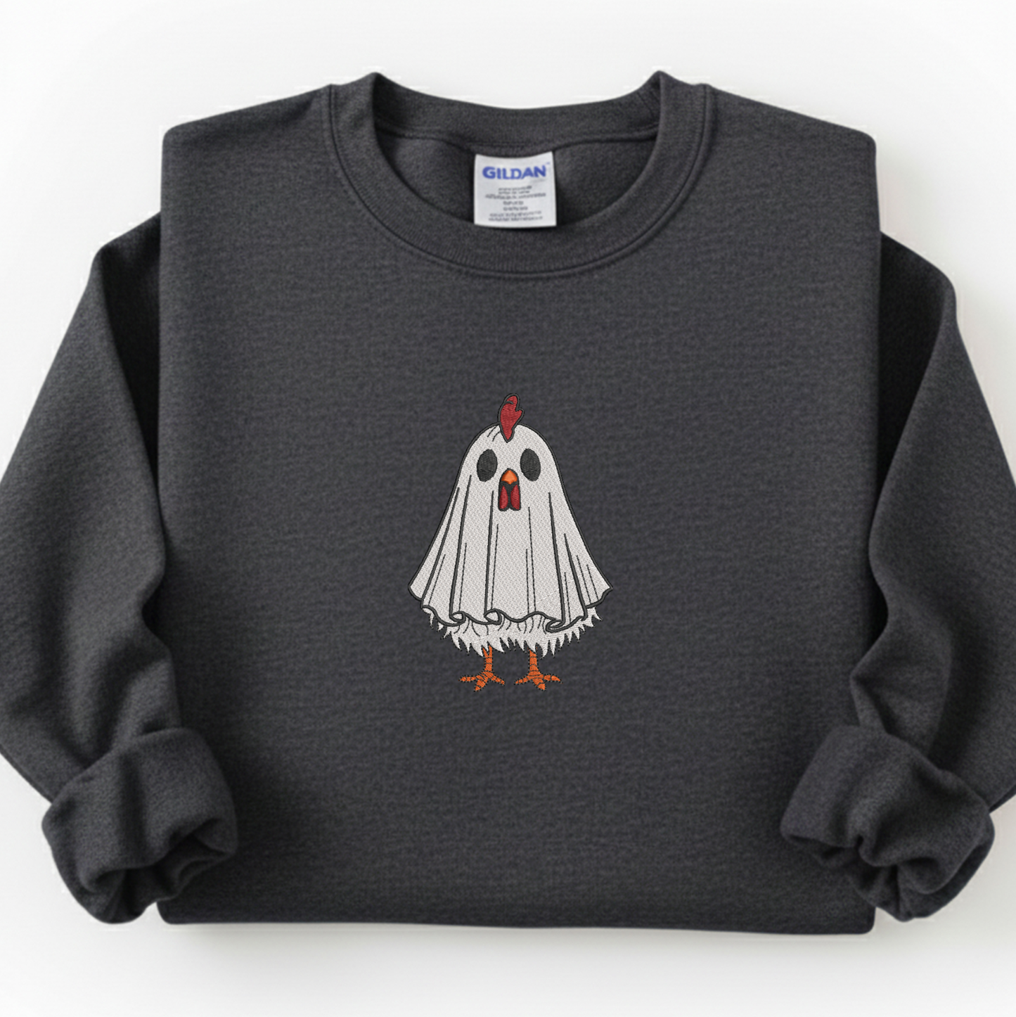A dark gray crewneck sweatshirt featuring a graphic of a white ghost chicken with orange feet and a red comb, displayed flat against a white background. The neck label shows the brand Gildan.