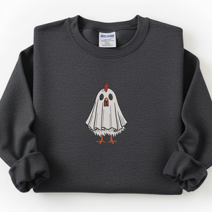 A dark gray crewneck sweatshirt featuring a graphic of a white ghost chicken with orange feet and a red comb, displayed flat against a white background. The neck label shows the brand Gildan.