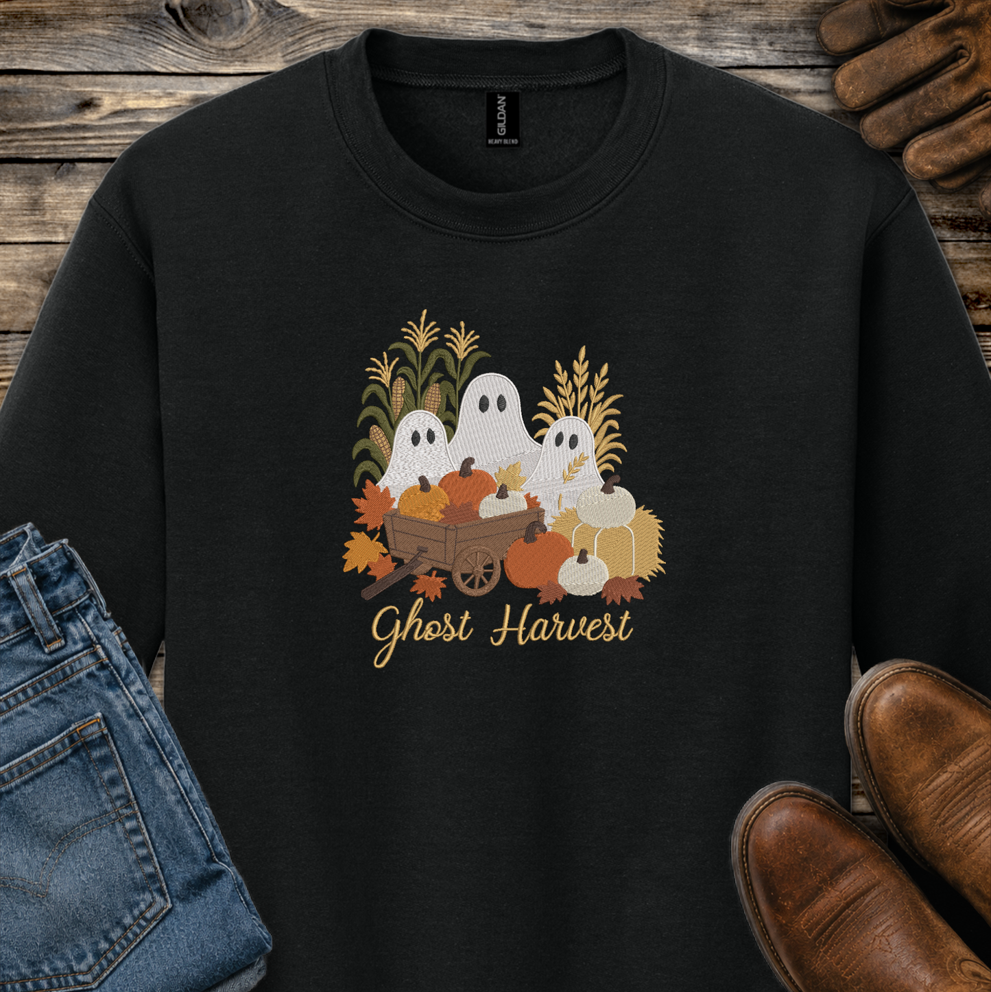 black sweatshirt with a fall season embroidered design of ghosts, pumpkins and leaves.