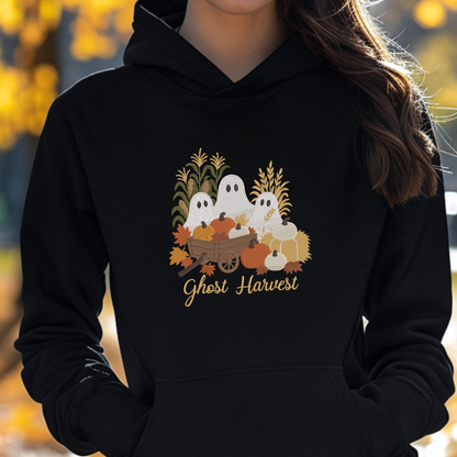 woman wearing a black sweatshirt with a fall season embroidered design of ghosts, pumpkins and leaves.