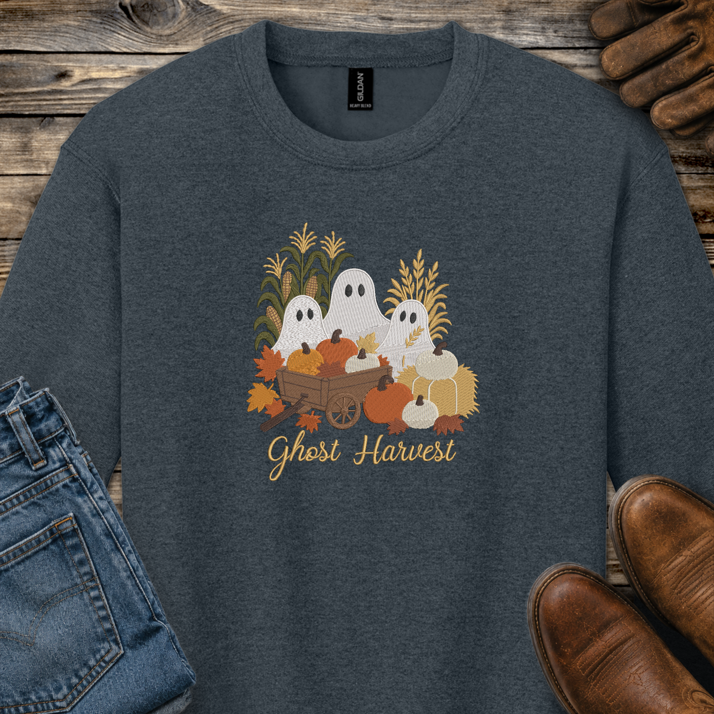 gray sweatshirt with a fall season embroidered design of ghosts, pumpkins and leaves.