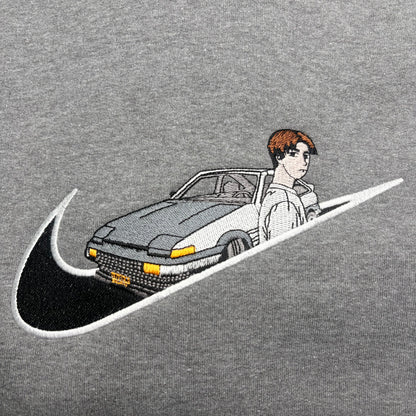 gray background with embroidered takumi and his AE86 car on it
